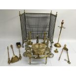 A collection of brassware including candlesticks and fire tools