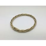 A 9ct yellow gold twisted design bangle, approx 17.2g.
