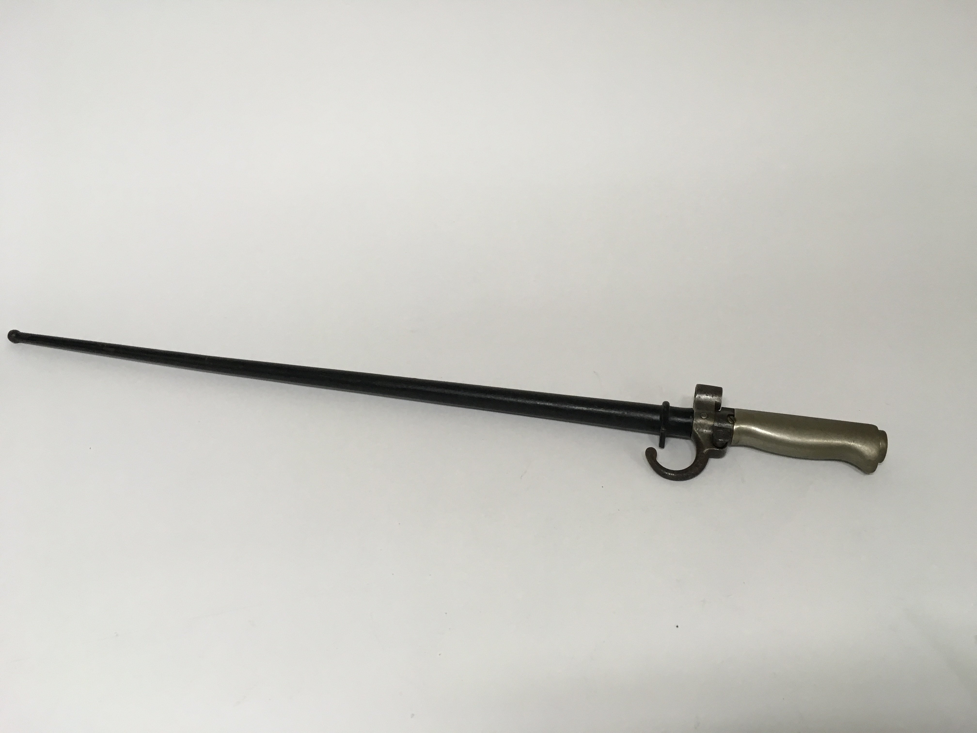 A French M1886 bayonet for use with the 8mm Lebel rifle. This bayonet has a locking mechanism for