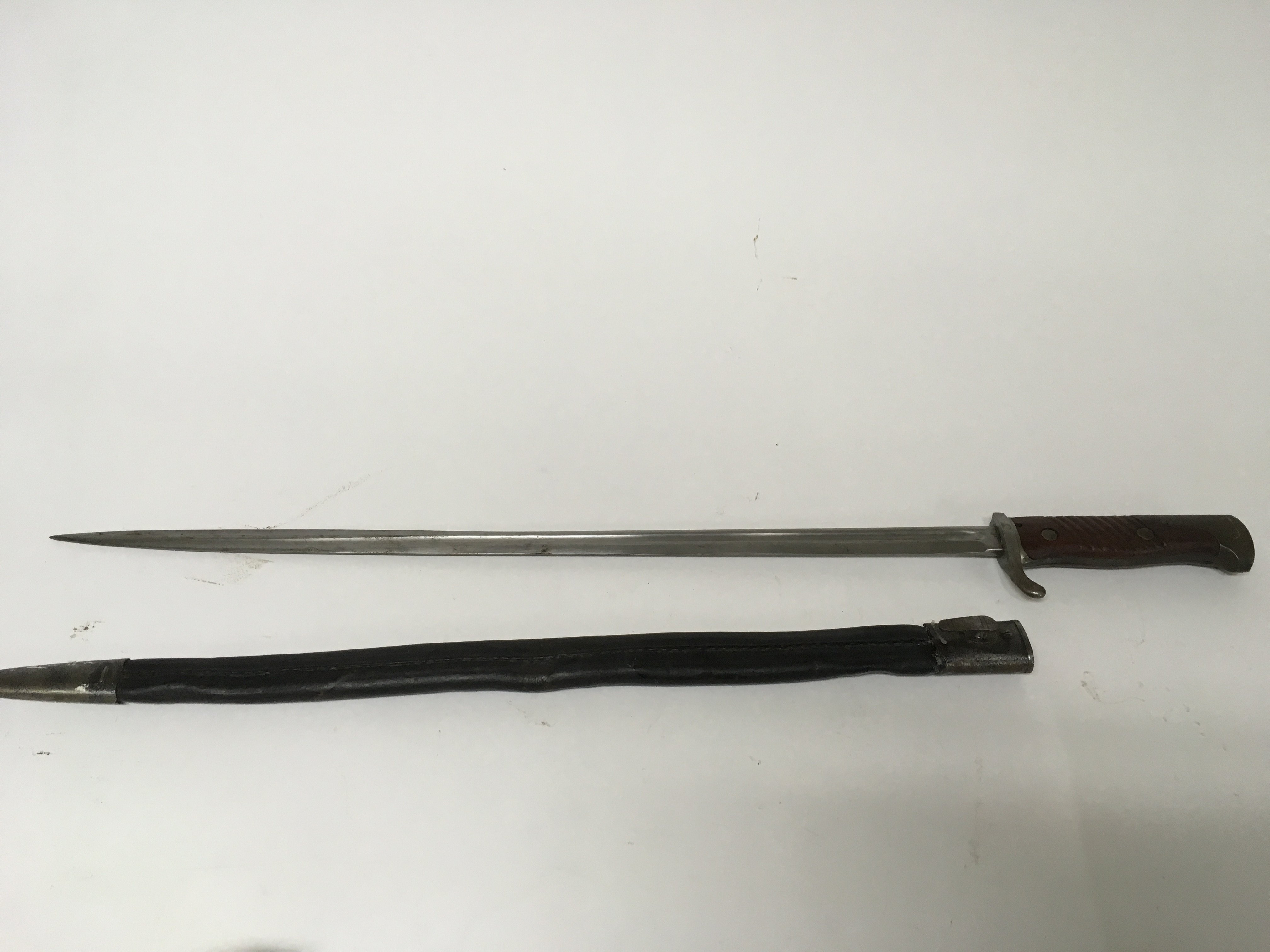 A German WW1 M1898 n/a bayonet manufactured by Simpson & Co in Suhl with a leather scabbard.