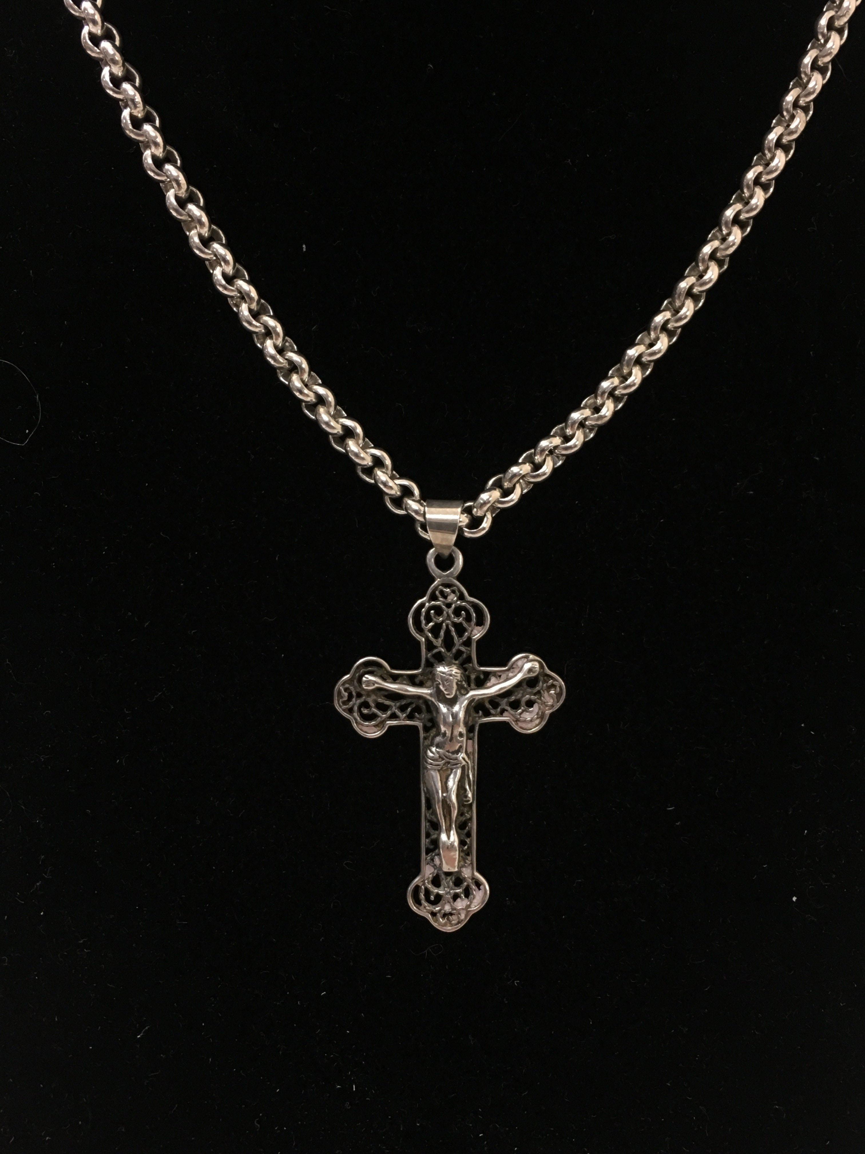 A large silver crucifix pendant on a silver chain.