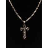 A large silver crucifix pendant on a silver chain.