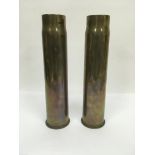 Two brass shell cases.