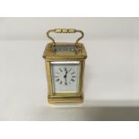 A small brass case carriage clock the enamel dial with Roman numerals