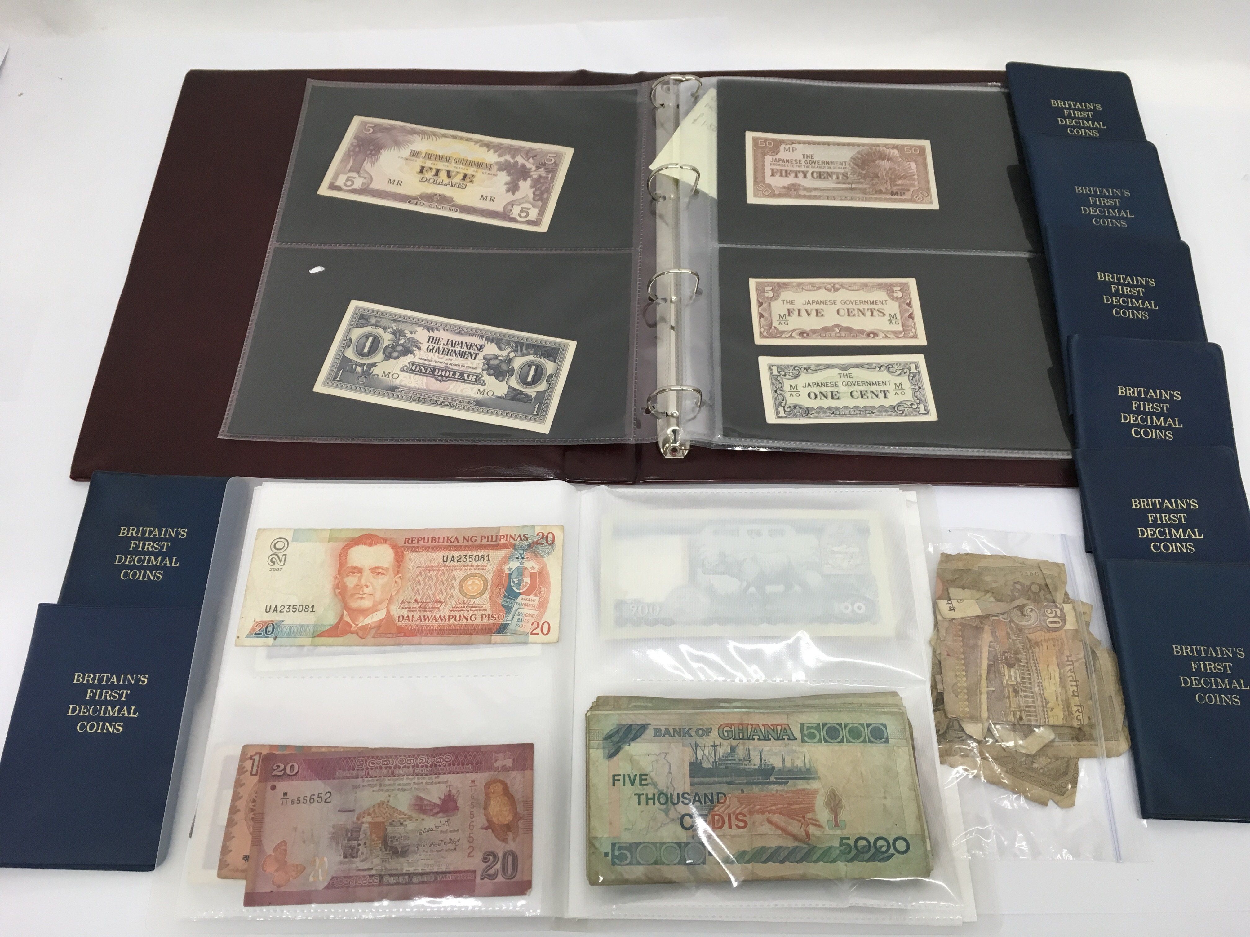 A box of world coins and bank notes to include Japanese notes.