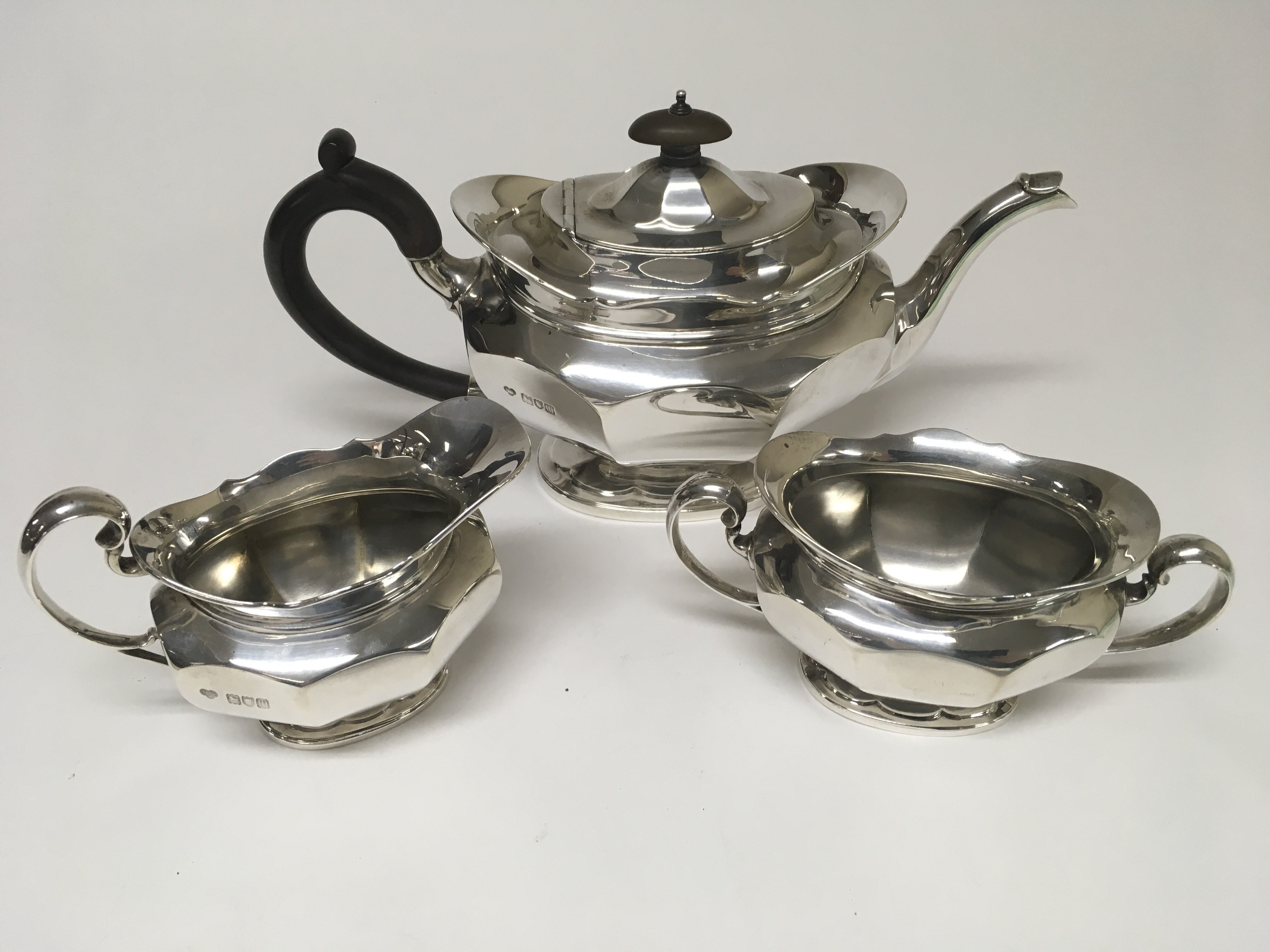 A three piece silver tea set comprising tea pot milk jug and sugar bowl London hallmark 1908