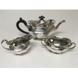 A three piece silver tea set comprising tea pot milk jug and sugar bowl London hallmark 1908