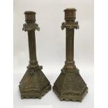 A pair of gothic style brass candle sticks, approx