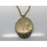 A 9ct Gold oval locket with attached 9ct Gold belc