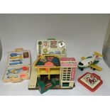 A boxed Fisher Price garage with unboxed items including a medical kit, activity centre, aeroplane