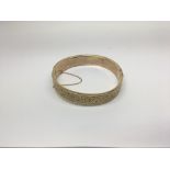 A 9ct Gold bangle with folate decoration, 23g appr