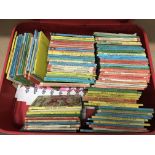 A suitcase containing various vintage Ladybird books.