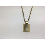 A modern 18ct gold pendant set with a small diamon