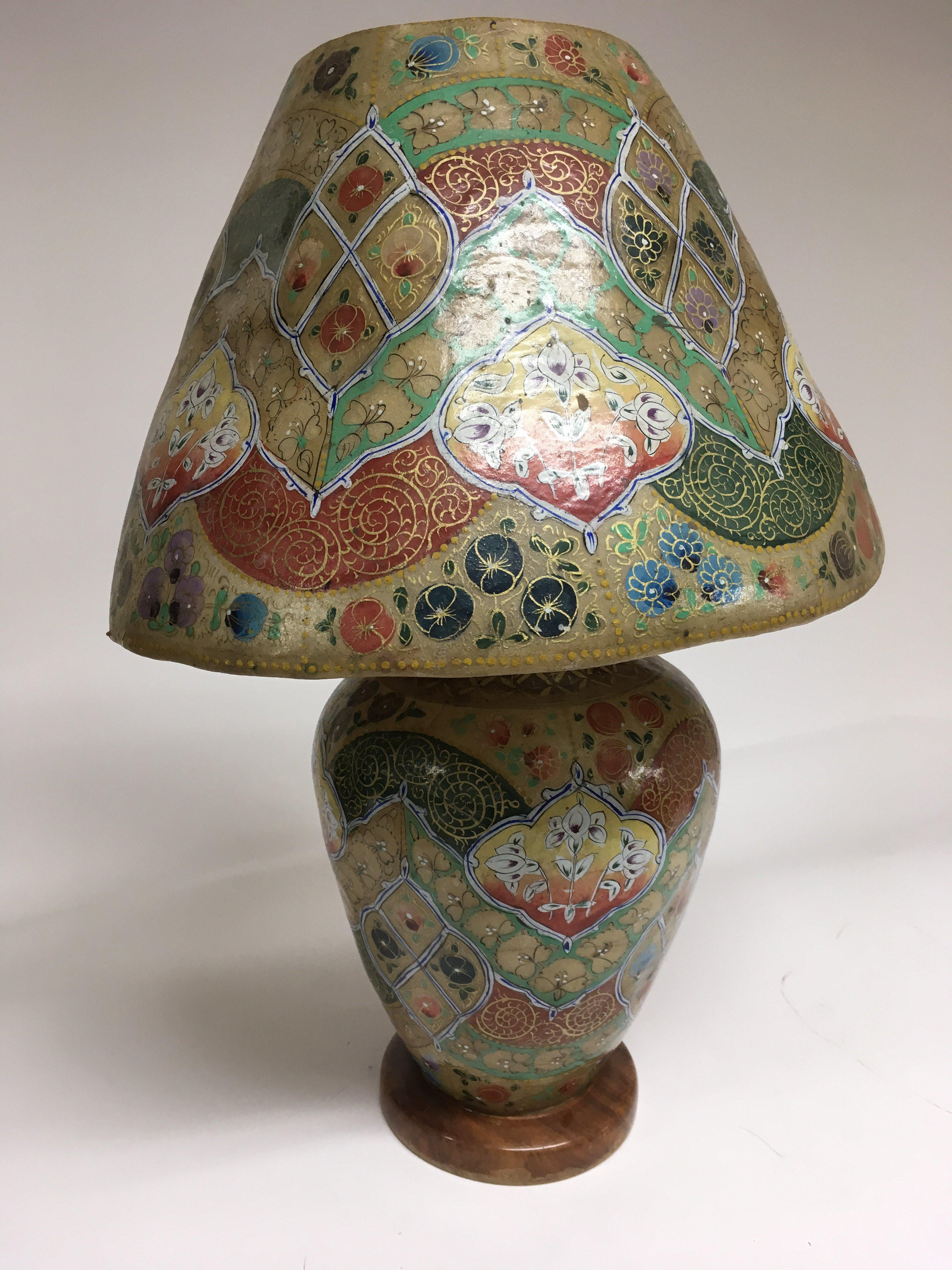 An Indian lamp and base made of skin, hand decorated