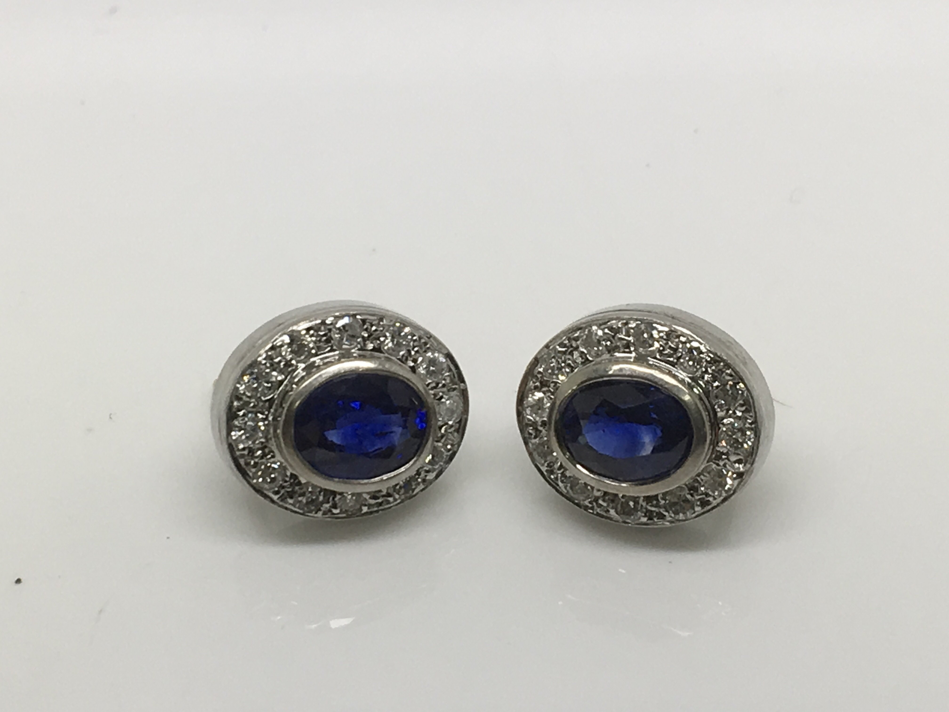 A pair of sapphire and diamond white gold earrings.