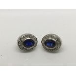 A pair of sapphire and diamond white gold earrings.