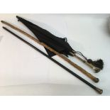 A silver topped walking stick, a Hawthorne walking stick and a parasol with some damage.