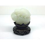 Another small carved, light green jade model of a
