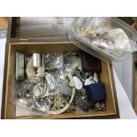 A wooden box of costume jewellery.