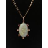 A 9ct gold chain with attached opal pendant, surrounded by four white diamonds and four rubies,