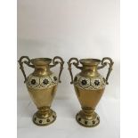 A pair of decorative brass twin handled vases