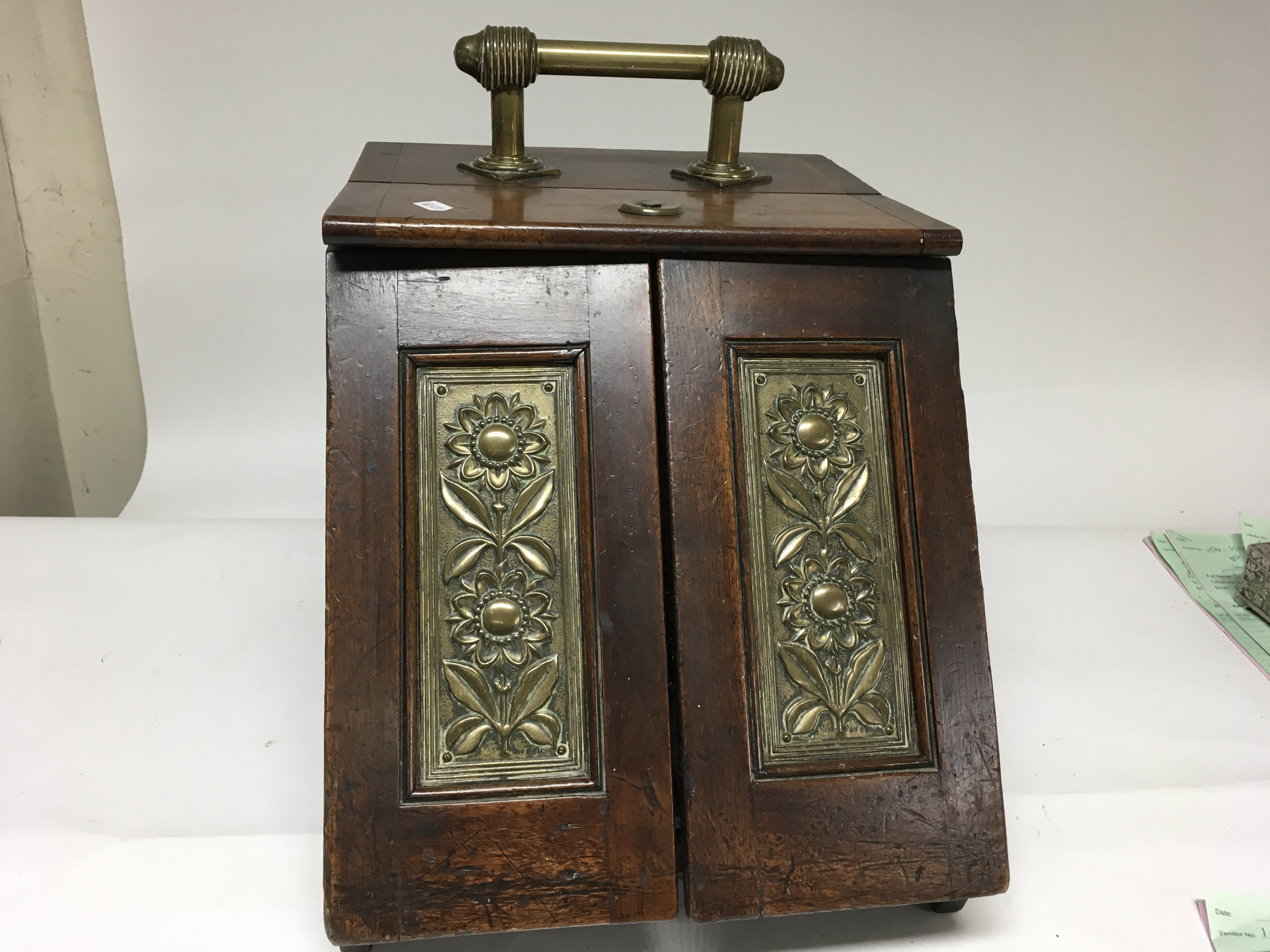 A brass mounted Edwardian coal box with a mirror.