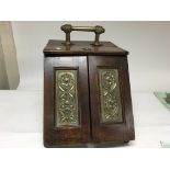 A brass mounted Edwardian coal box with a mirror.