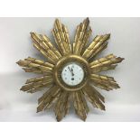 A sunburst clock. Diameter approx 58cm