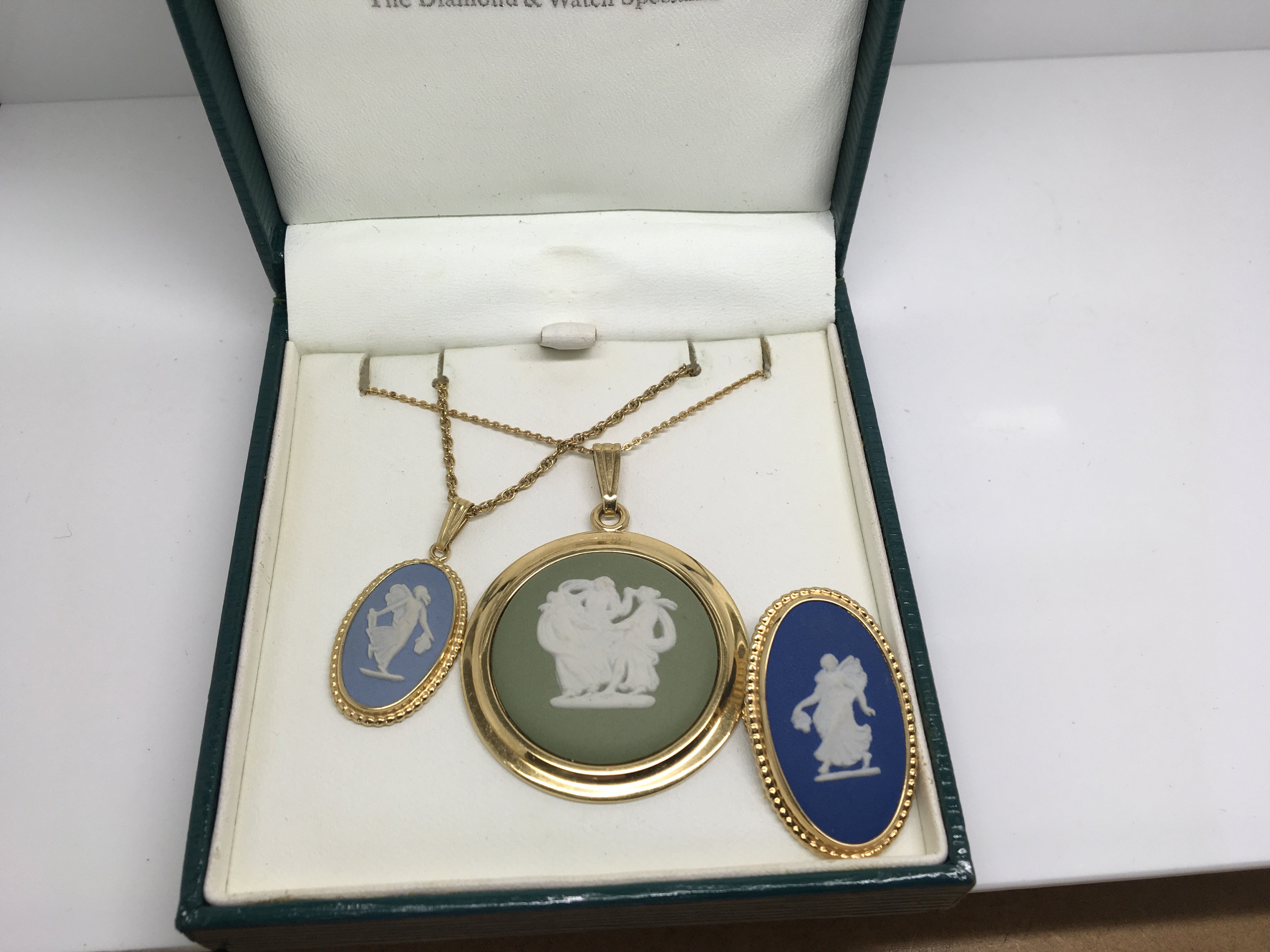 Two Wedgwood cameo necklaces together with a brooch.