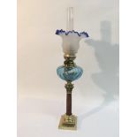 An oil lamp with blue and clear glass shade plus a blue glass reservoir, approx 54.5cm.