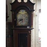 A reproduction mahogany ecs Westminster chiming German clock with three visible weights and a