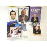 A collection of signed books and photos to include Lee Evans, Des O'Connor, Michael Parkinson,
