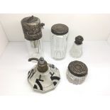 Four silver topped glass vanity bottles and an Art