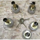A five arm drop ceiling light with brass fittings