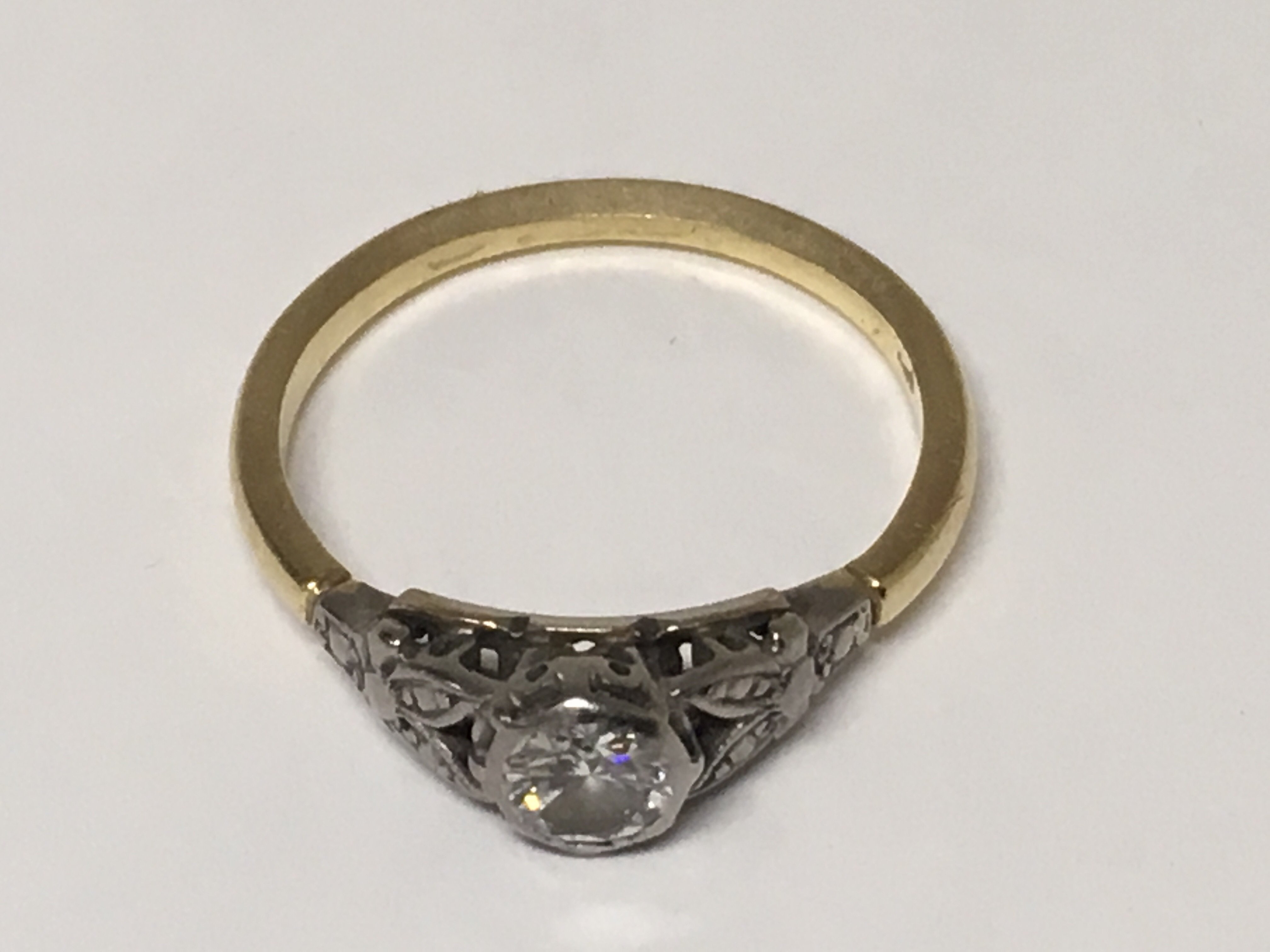 A diamond solitaire old cut ring with unmarked gold band