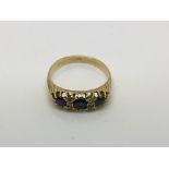 A gold ring set with sapphires, approx size O-P and approx 4g.