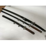 A set of three reproduction samurai swords.