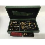 A jewellery box of gold and gold tone jewellery including tie pins and earrings.