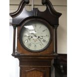 A oak long case clock the white painted circular dial with Roman numerals and second subsidiary dial