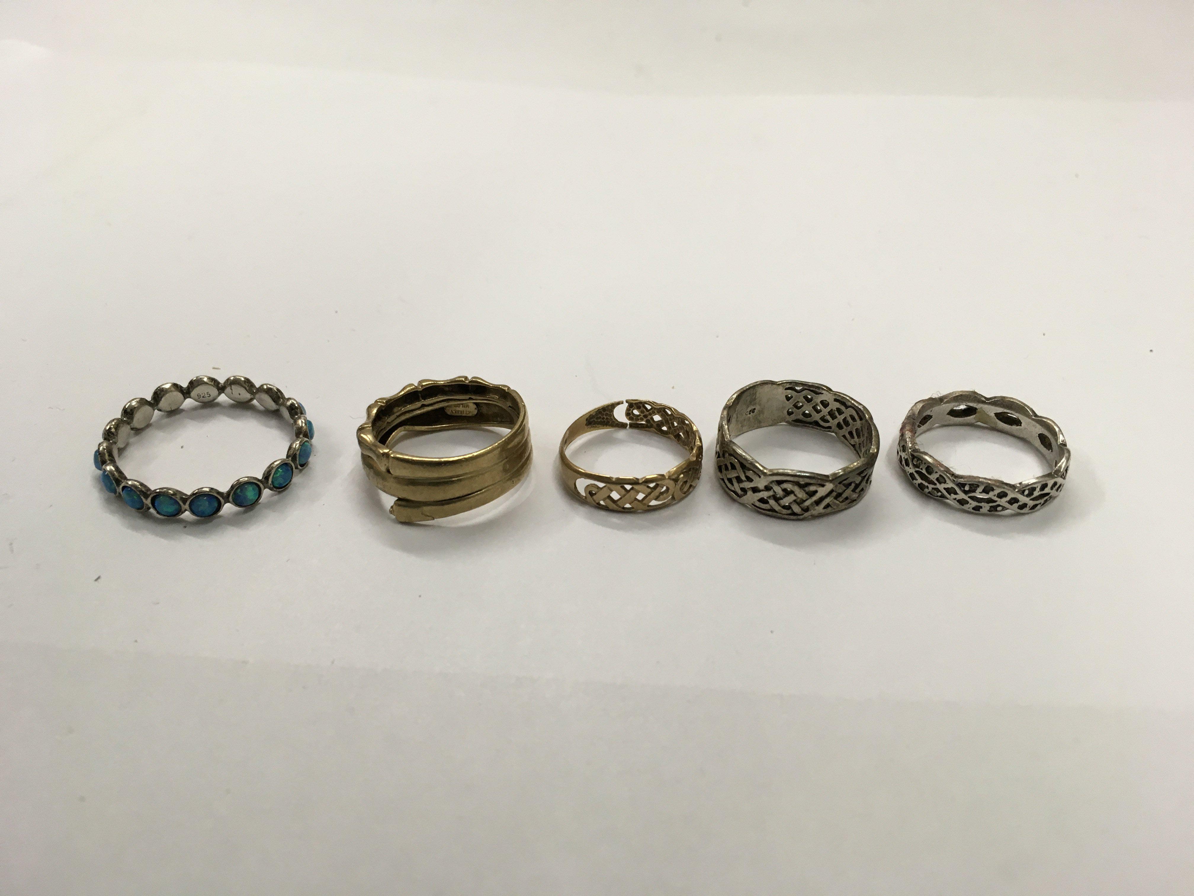 A collection of gold earrings, two other rings and various other rings.