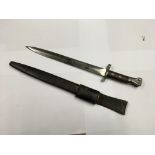 A British Pattern 1888 Mk.1 bayonet with a leather scabbard.