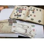 A stamp album and collection of first day covers.
