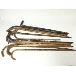 A collection of 12 vintage walking sticks all with