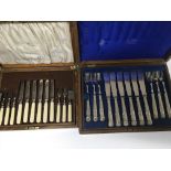 Two oak mappin and Webb cases containing fish knifes and forks and fruit knifes and forks