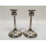A pair of silver candlesticks, hallmarks indistinct, approx 16.5cm.