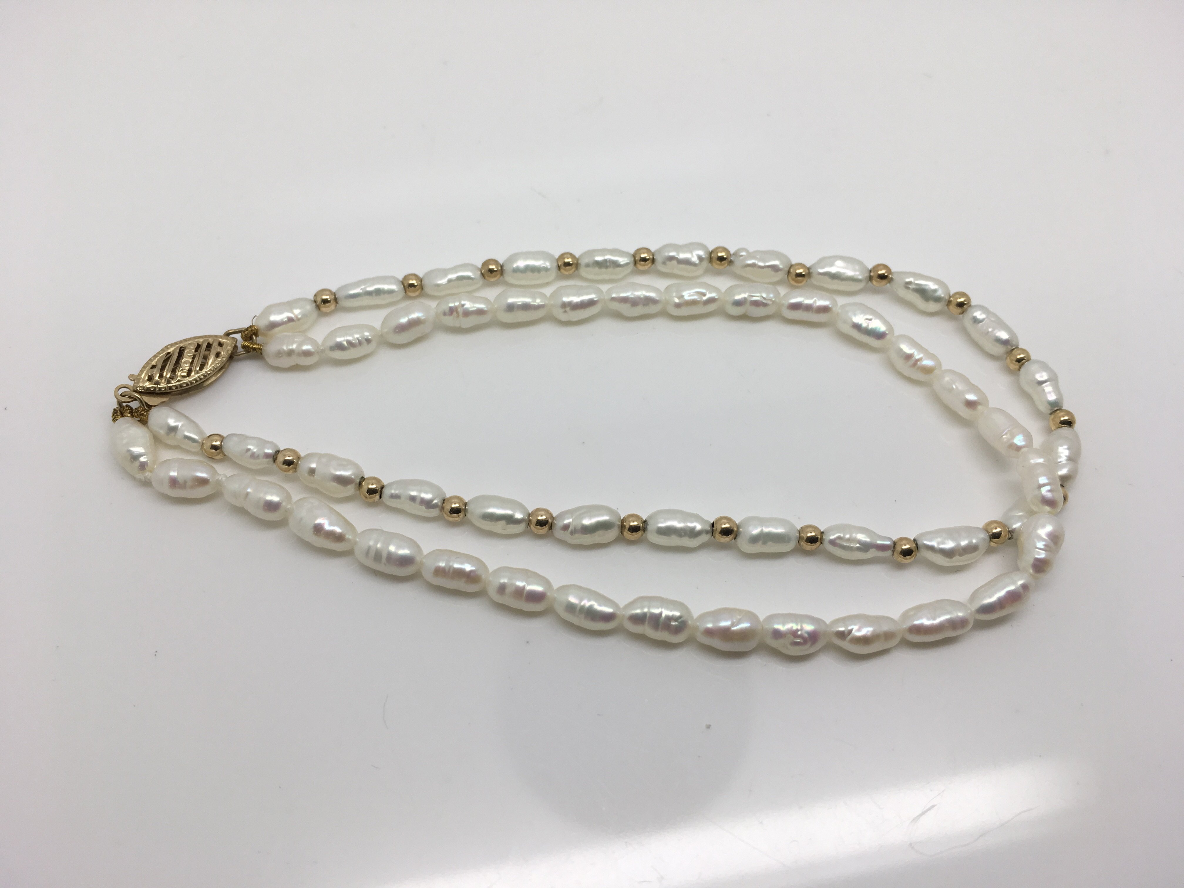 A 9ct gold bracelet with freshwater pearls. Weight approx 6.8g