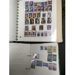 A collection of empty stamp albums with some containing a few stamps.