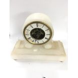 A small alabaster sketleton mechansism mantle clock 23cm in height - 1 foot loose