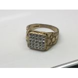 A Gents 9ct gold ring set with a square pattern of diamonds. Ring size z+.1