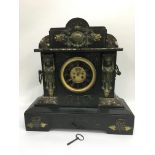 An eight day slate and marble mantle clock with ch